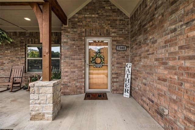 7380 Royalwood Way, Tulsa, OK 74131 - view of exterior entry featuring brick siding and a porch