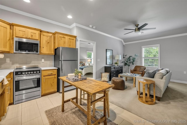 7380 Royalwood Way, Tulsa, OK 74131 - kitchen featuring appliances with stainless steel finishes, a ceiling fan, light countertops, tasteful backsplash, and crown molding