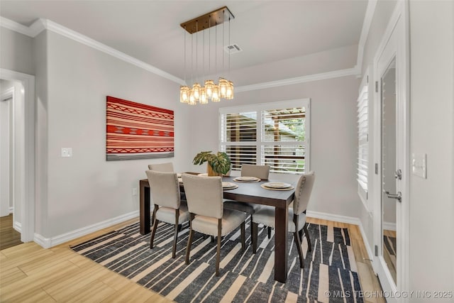 7380 Royalwood Way, Tulsa, OK 74131 - dining space with wood finished floors, crown molding, and a chandelier
