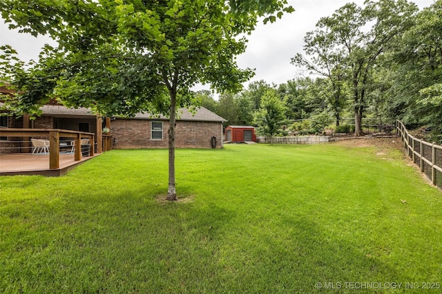 7380 Royalwood Way, Tulsa, OK 74131 - fenced backyard with a deck and a storage unit