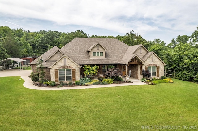 7380 Royalwood Way, Tulsa, OK 74131 - view of front facade featuring stone siding, a front lawn, a detached carport, a shingled roof, and covered porch