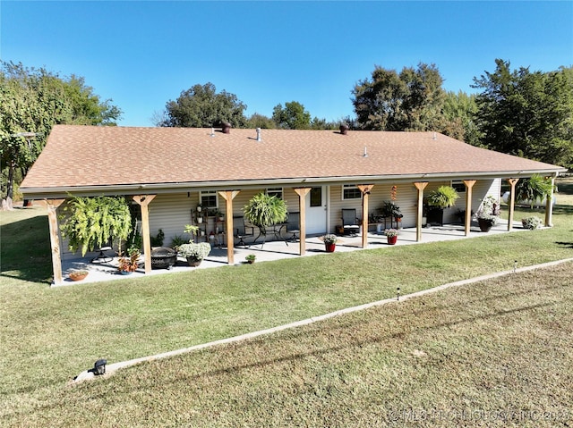 419124 E 1144th Rd, Checotah, OK 74426 - rear view of property with a patio, a yard, a shingled roof, and an outdoor fire pit