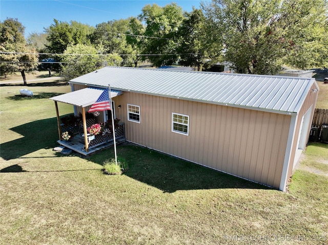 419124 E 1144th Rd, Checotah, OK 74426 - view of side of home featuring a lawn and a metal roof
