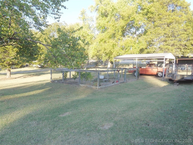 419124 E 1144th Rd, Checotah, OK 74426 - view of green lawn with a carport and a garden