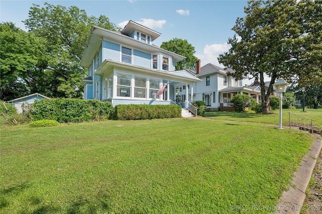 415 S 13th St, Muskogee, OK 74401 - traditional style home featuring a front yard and a sunroom