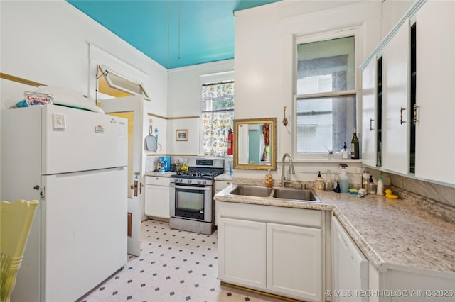 415 S 13th St, Muskogee, OK 74401 - kitchen with white appliances, light flooring, light countertops, and white cabinets