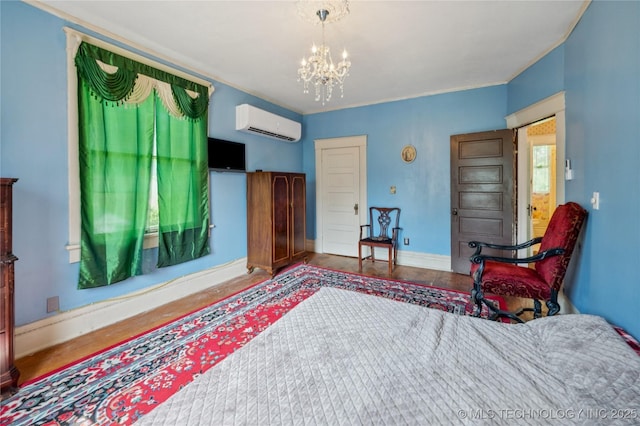 415 S 13th St, Muskogee, OK 74401 - bedroom with a wall mounted AC, a chandelier, and wood finished floors