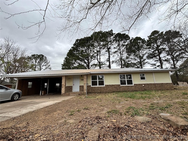 305 NW 4th St Unit 1/2, Wilburton, OK 74578 - view of front of house with driveway, brick siding, and a carport