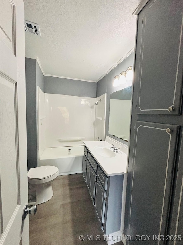305 NW 4th St Unit 1/2, Wilburton, OK 74578 - bathroom with vanity, a textured ceiling, crown molding, wood finished floors, and shower / bath combination