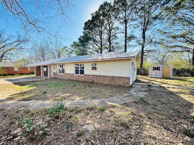 305 NW 4th St Unit 1/2, Wilburton, OK 74578 - single story home with a storage unit, brick siding, and a metal roof