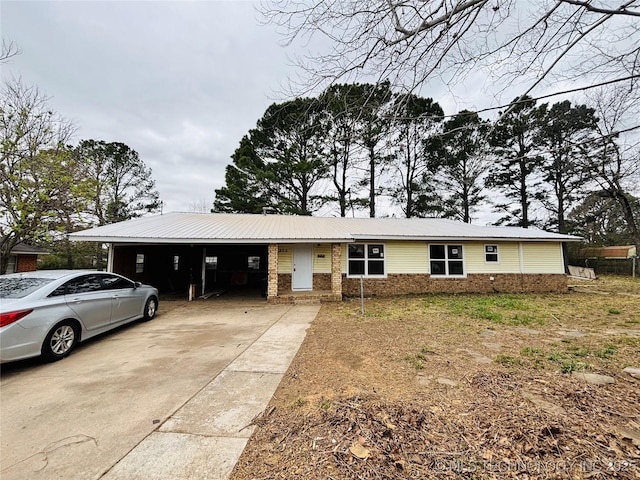 305 NW 4th St Unit 1/2, Wilburton, OK 74578 - view of front of house with brick siding, driveway, and a metal roof