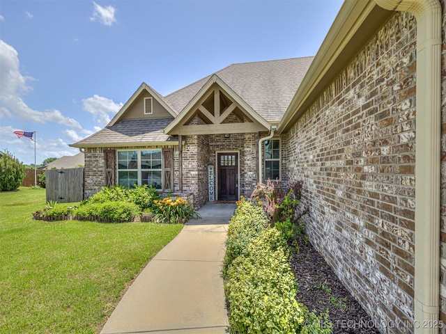 7616 E 84th St, Owasso, OK 74021 - doorway to property featuring roof with shingles and brick siding