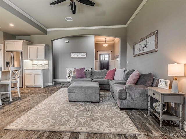 7616 E 84th St, Owasso, OK 74021 - living area featuring arched walkways, ceiling fan, crown molding, and dark wood finished floors