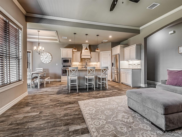 7616 E 84th St, Owasso, OK 74021 - living room with dark wood-style floors, crown molding, a chandelier, ceiling fan, and recessed lighting