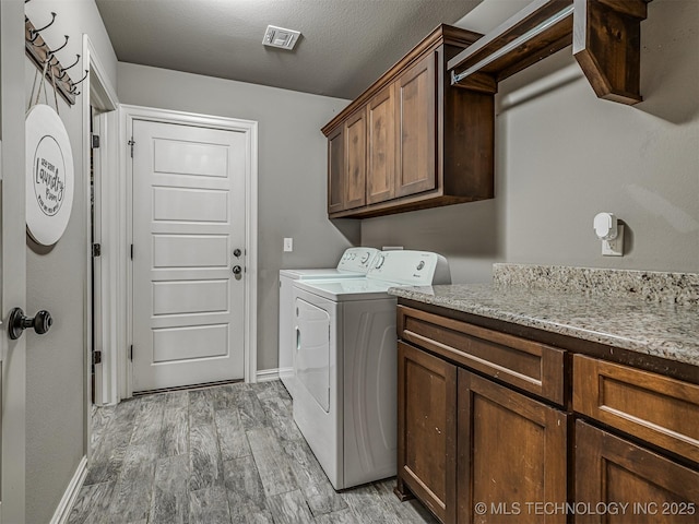 7616 E 84th St, Owasso, OK 74021 - laundry area featuring washer and dryer, cabinet space, and light wood-type flooring