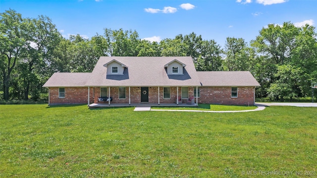 9644 Ew 19 Rd, Nowata, OK 74048 - cape cod-style house featuring covered porch, brick siding, and a front lawn