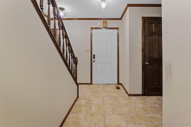 9644 Ew 19 Rd, Nowata, OK 74048 - foyer featuring ornamental molding, stairway, and a textured ceiling