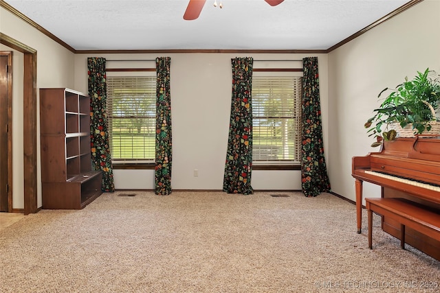 9644 Ew 19 Rd, Nowata, OK 74048 - living area with ornamental molding, plenty of natural light, a ceiling fan, carpet, and a textured ceiling