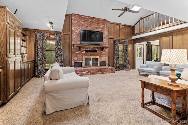 9644 Ew 19 Rd, Nowata, OK 74048 - living room featuring wooden walls, high vaulted ceiling, light carpet, ceiling fan, and a fireplace
