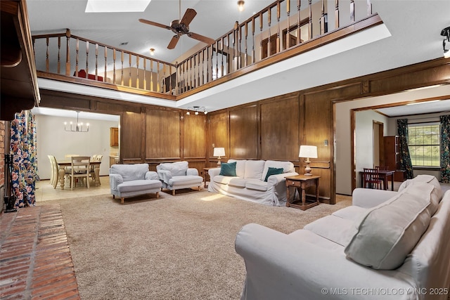 9644 Ew 19 Rd, Nowata, OK 74048 - living room with a high ceiling, a chandelier, ceiling fan, a skylight, and wood walls