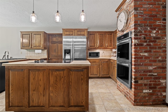 9644 Ew 19 Rd, Nowata, OK 74048 - kitchen with black appliances, a center island, decorative backsplash, light tile patterned flooring, and pendant lighting