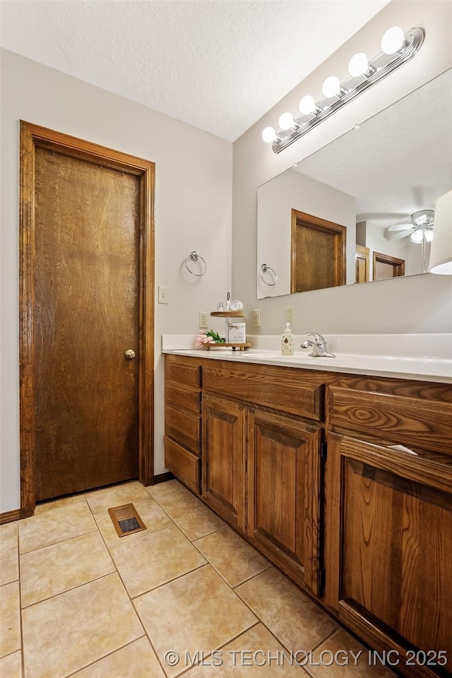 9644 Ew 19 Rd, Nowata, OK 74048 - bathroom with vanity, ceiling fan, tile patterned floors, and a textured ceiling