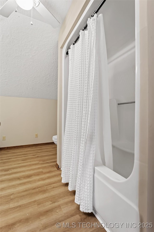 9644 Ew 19 Rd, Nowata, OK 74048 - bathroom with wood finished floors, shower / bath combo, and a ceiling fan