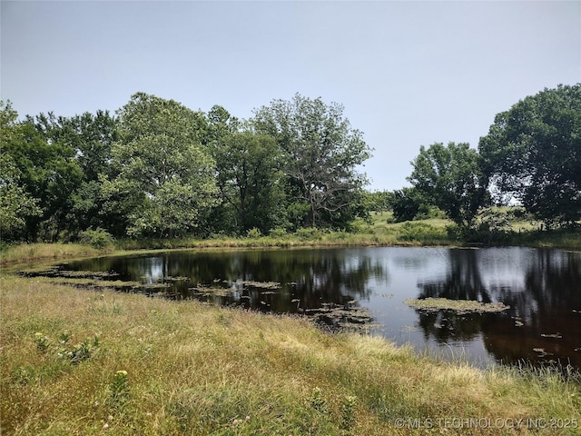 9644 Ew 19 Rd, Nowata, OK 74048 - water view with a heavily wooded area