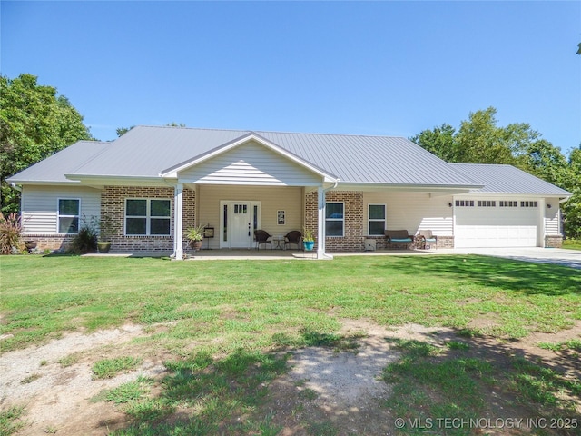 414467 E 1090th Rd, Checotah, OK 74426 - view of front of home with a garage, a front yard, brick siding, a metal roof, and driveway