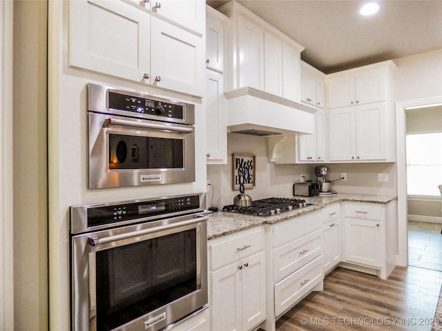 414467 E 1090th Rd, Checotah, OK 74426 - kitchen featuring stainless steel gas cooktop, white cabinetry, wood finished floors, light stone counters, and recessed lighting