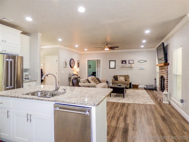414467 E 1090th Rd, Checotah, OK 74426 - kitchen with stainless steel dishwasher, ornamental molding, open floor plan, a ceiling fan, and dark wood-style flooring