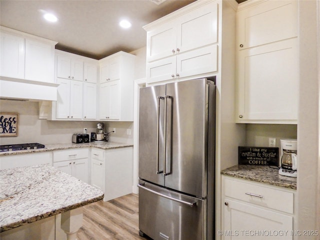 414467 E 1090th Rd, Checotah, OK 74426 - kitchen featuring stainless steel appliances, light wood finished floors, white cabinetry, recessed lighting, and light stone countertops