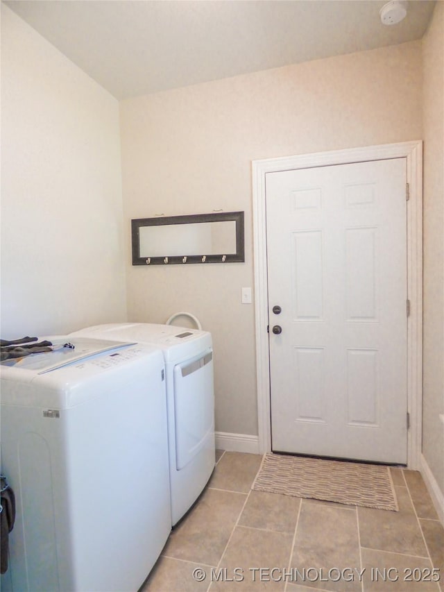 414467 E 1090th Rd, Checotah, OK 74426 - laundry area featuring washing machine and clothes dryer and light tile patterned floors