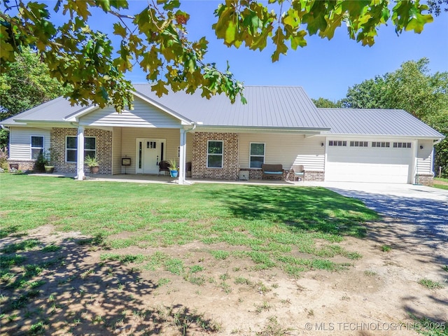 414467 E 1090th Rd, Checotah, OK 74426 - view of front facade featuring driveway, a garage, a front lawn, and brick siding