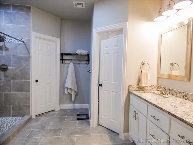 414467 E 1090th Rd, Checotah, OK 74426 - bathroom with vanity, a tile shower, and tile patterned flooring