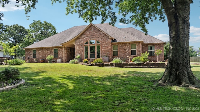 12920 E 183rd St S, Bixby, OK 74008 - view of front facade with brick siding, a front lawn, and roof with shingles