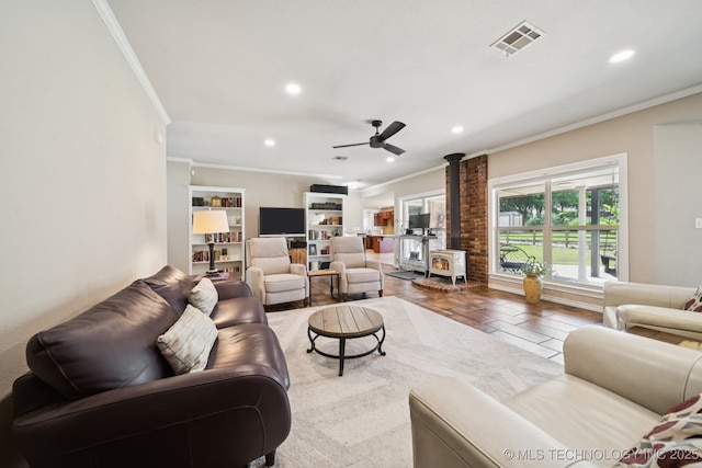 12920 E 183rd St S, Bixby, OK 74008 - living area with a wood stove, crown molding, recessed lighting, and ceiling fan