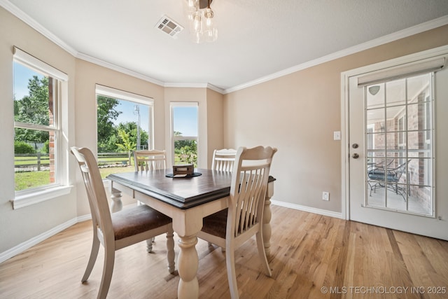 12920 E 183rd St S, Bixby, OK 74008 - dining space with light wood-type flooring, healthy amount of natural light, and ornamental molding