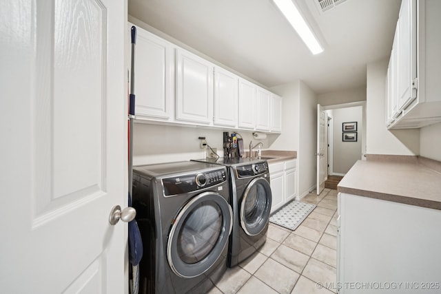 12920 E 183rd St S, Bixby, OK 74008 - laundry area featuring washing machine and dryer, cabinet space, and light tile patterned floors