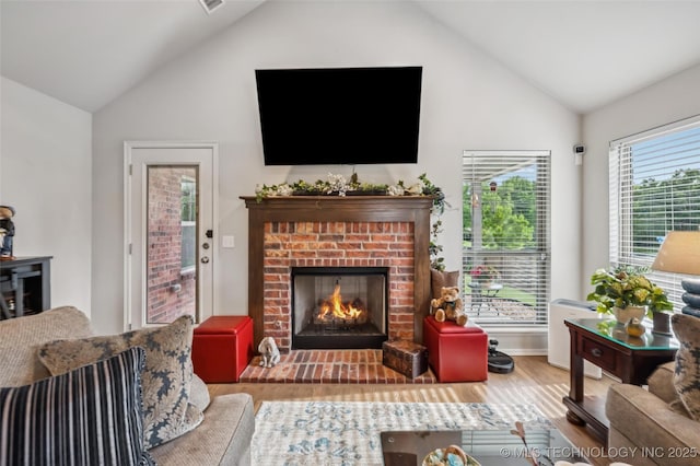 2402 W Kingsport Ct S, Broken Arrow, OK 74011 - living room with wood finished floors, a brick fireplace, and high vaulted ceiling