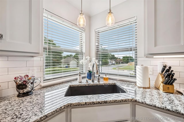 2402 W Kingsport Ct S, Broken Arrow, OK 74011 - kitchen view of backsplash, white cabinetry, and pendant lighting