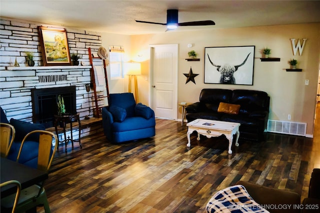330 Kiamichi, Eufaula, OK 74432 - living area with wood finished floors, ceiling fan, and a stone fireplace