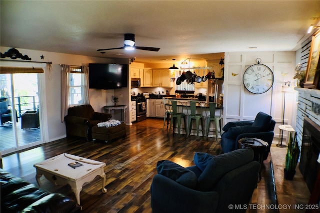 330 Kiamichi, Eufaula, OK 74432 - living area with ceiling fan, a fireplace, and dark wood-type flooring