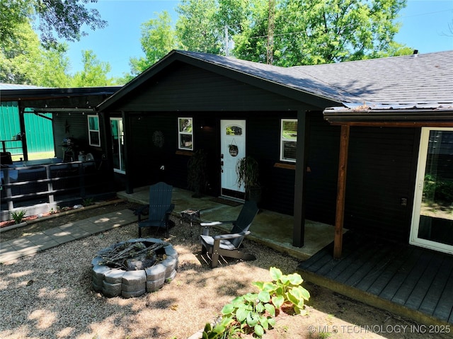 330 Kiamichi, Eufaula, OK 74432 - single story home featuring a fire pit and roof with shingles