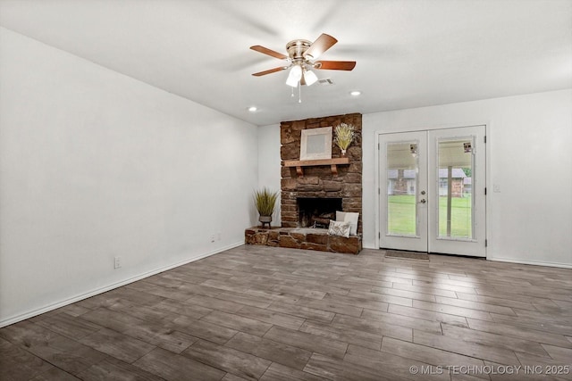 30078 E 143rd St S, Coweta, OK 74429 - unfurnished living room with ceiling fan, wood finished floors, french doors, a stone fireplace, and recessed lighting