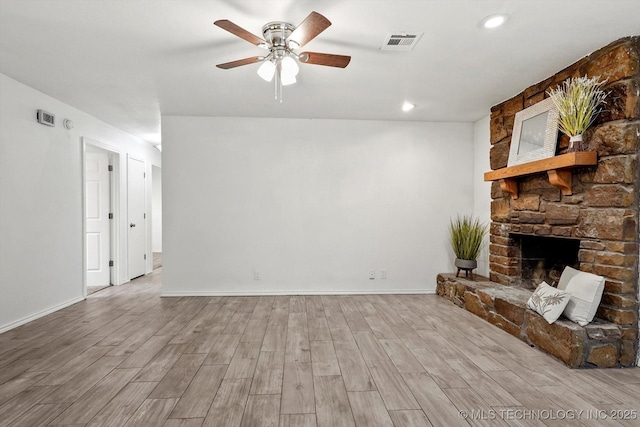 30078 E 143rd St S, Coweta, OK 74429 - unfurnished living room featuring ceiling fan, wood finished floors, a stone fireplace, and recessed lighting