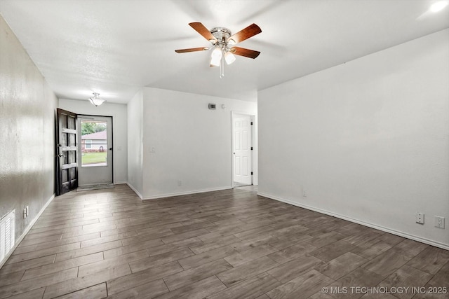 30078 E 143rd St S, Coweta, OK 74429 - empty room with a ceiling fan and dark wood-type flooring