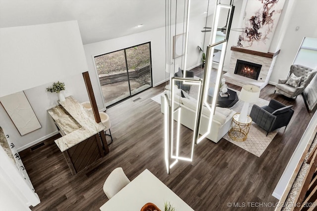 2012 N Santa Fe Ave, Tulsa, OK 74127 - living area featuring wood finished floors and a warm lit fireplace