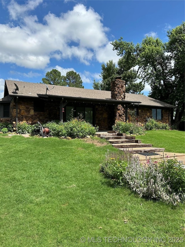 23536 Timber Trl W, Bristow, OK 74010 - back of house featuring stone siding, a chimney, and a lawn