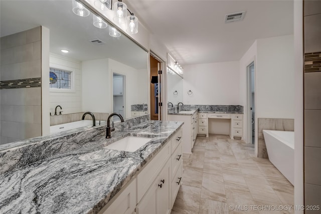 6904 E 86th Pl N, Owasso, OK 74055 - bathroom featuring two vanities, a freestanding tub, and marble finish floors